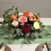 Stunning Floral Arrangement by Blooms Collection: Vibrant magenta, yellow, orange, and pink tones with roses, peonies, eucalyptus, and rose leaves. Ideal for weddings, corporate events, birthdays, and evening functions.